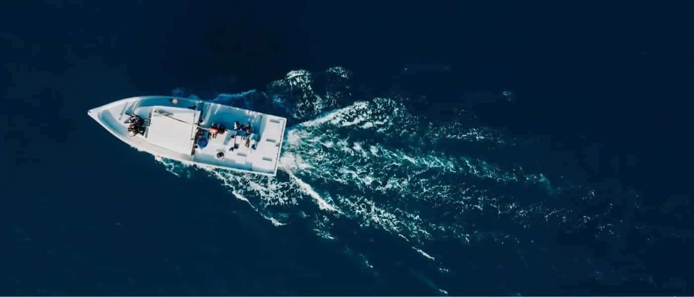 A speed boat seen from above on deep blue water