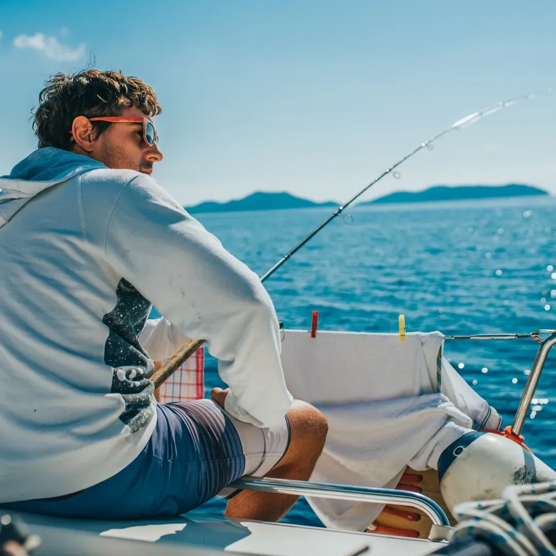 An angler casting from a boat off Dubai