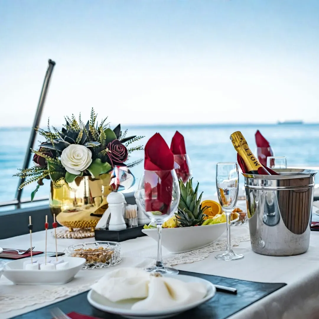 A table set for lunch on board, with white flowers and glassware