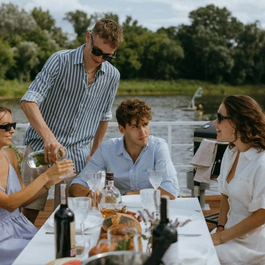 A private dining table set by the water