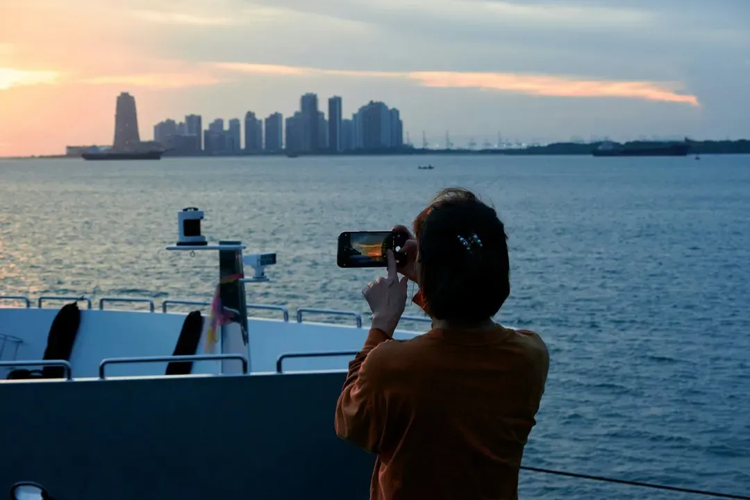 A photographer capturing the skyline from a yacht
