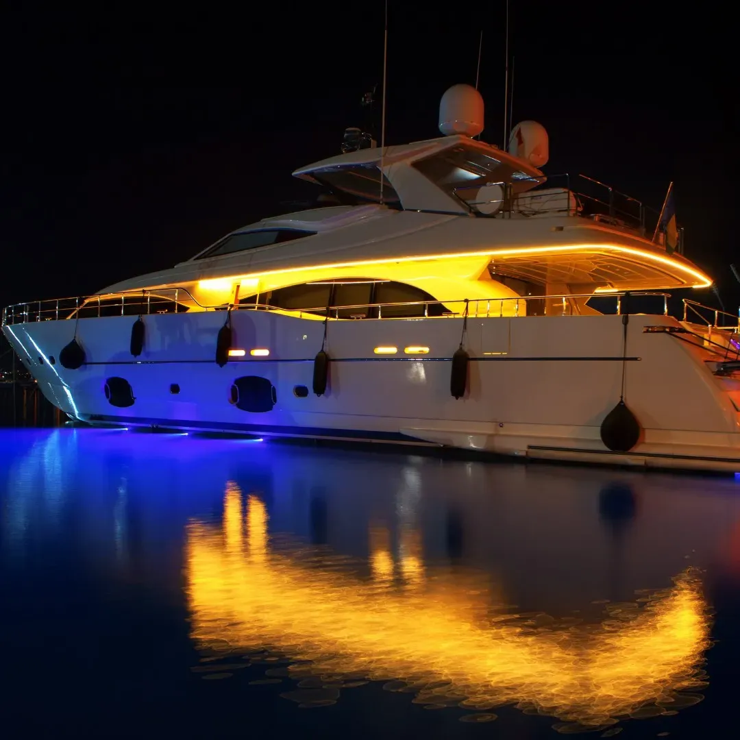 A yacht lit up at night in Dubai Marina
